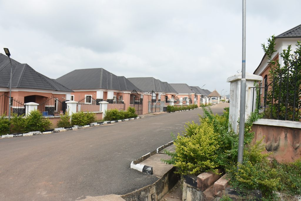 Street-lit Winners Estate road lined with completed homes